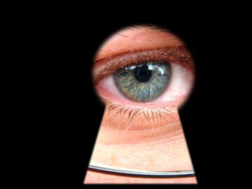 eye peeping through keyhole