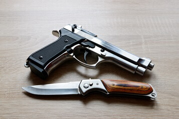 gun-and-knife-on-tabletop-weapons (1) weapons gun and knife on table