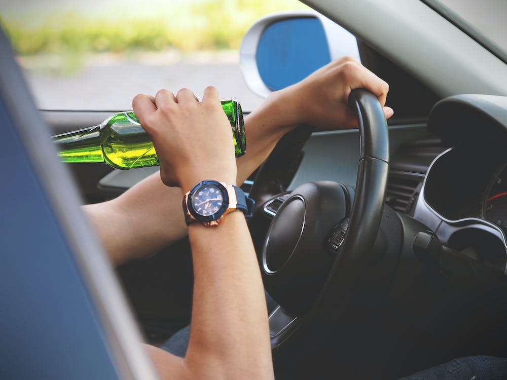 motorist drinking bottle of beer while driving motorist drinking bottle of beer while driving